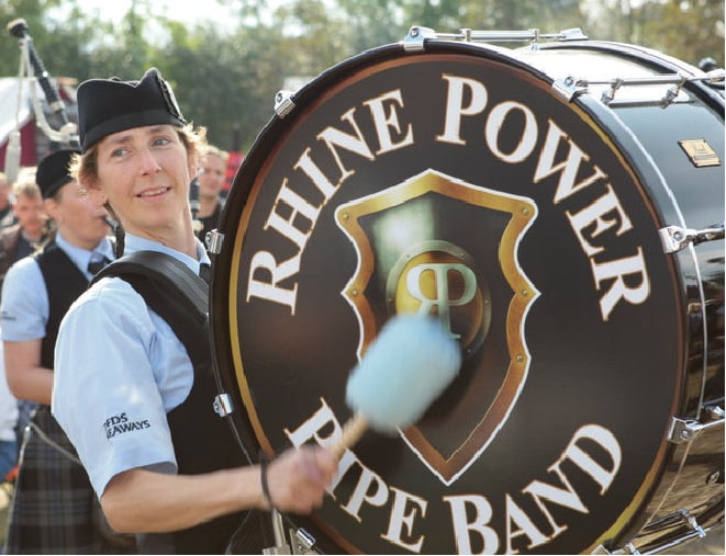 Pipe band drummer playing pipe band printed bass drum head