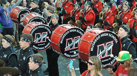 Marching band bass drummers playing custom marching bass drum heads