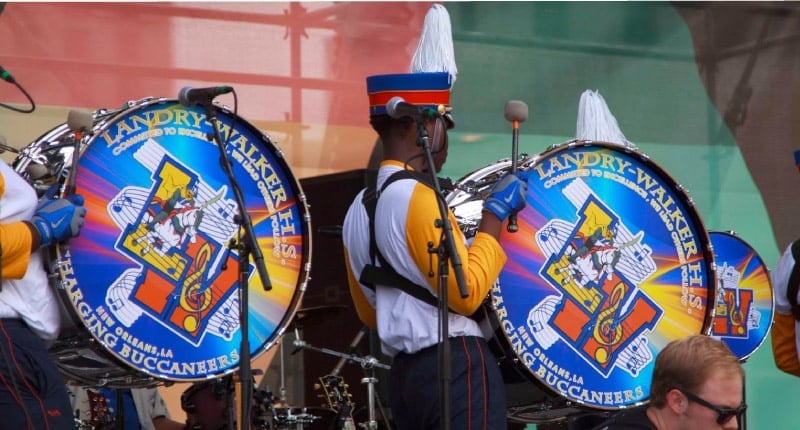 Two marching bass drummers playing printed marching band bass drum heads